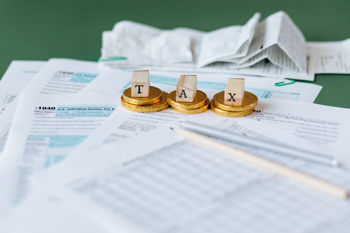 Accountant preparing financial statements with reports and a calculator