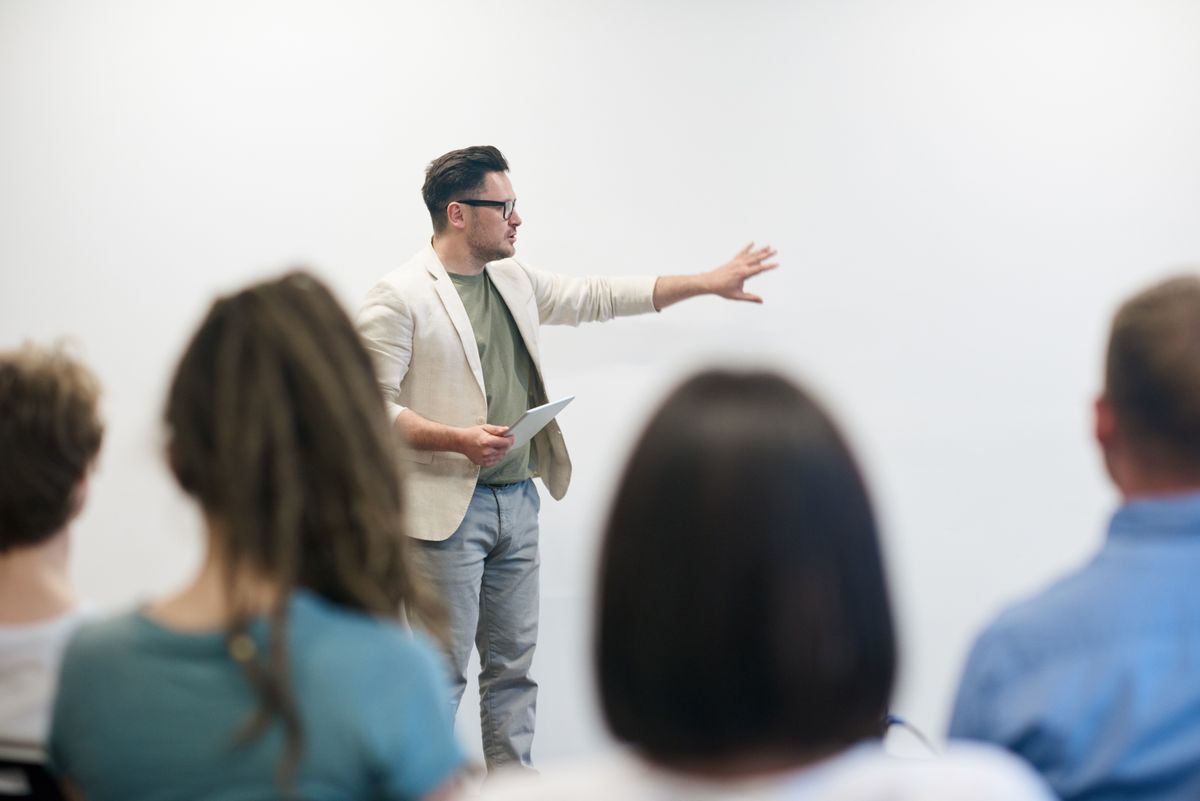 Professional trainer leading a corporate training workshop with a team